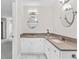 Bathroom with white cabinetry, dual sinks, framed mirrors, and modern light fixtures at 1428 Brookcliff Dr, Marietta, GA 30062