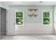 This bedroom has neutral walls, two windows with natural light, and wood shelves at 1428 Brookcliff Dr, Marietta, GA 30062