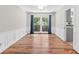 Dining room featuring hardwood floors, large window with blue curtains and white chair railing at 1428 Brookcliff Dr, Marietta, GA 30062