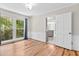 Dining room with hardwood floors, paneled walls, and view of kitchen through a doorway at 1428 Brookcliff Dr, Marietta, GA 30062