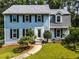 Charming two-story home with black shutters, manicured landscaping, and a welcoming walkway leading to the front door at 1428 Brookcliff Dr, Marietta, GA 30062