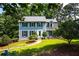 Charming two-story home with a well-manicured lawn, inviting walkway, and mature trees creating a serene setting at 1428 Brookcliff Dr, Marietta, GA 30062
