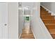 Bright hallway with hardwood floors, white walls, and a staircase leading to the upper level at 1428 Brookcliff Dr, Marietta, GA 30062