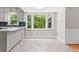 Bright kitchen with white cabinets, tile flooring, modern appliances, and a large window showcasing the natural surroundings at 1428 Brookcliff Dr, Marietta, GA 30062