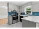 Modern kitchen with white cabinetry, sleek appliances, a stylish backsplash, and a functional layout for cooking and entertaining at 1428 Brookcliff Dr, Marietta, GA 30062