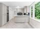 Well-lit kitchen featuring white cabinets, granite countertops, modern appliances, and tile flooring, offering a functional design at 1428 Brookcliff Dr, Marietta, GA 30062