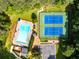 Aerial view of a pool and tennis courts in community surrounded by mature trees at 1428 Brookcliff Dr, Marietta, GA 30062