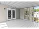 View of the porch with gray planks and screening showing the homes exterior with green trees at 1428 Brookcliff Dr, Marietta, GA 30062