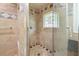 Shower stall showcasing beautiful tile work and a unique decorative window at 6771 Sunny Brook Ln, Atlanta, GA 30328
