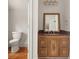 Small bathroom with pedestal sink and decorative mirror at 6771 Sunny Brook Ln, Atlanta, GA 30328
