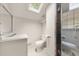 Modern bathroom with a skylight, glass shower, and white tile flooring at 6771 Sunny Brook Ln, Atlanta, GA 30328