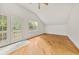 Bright bedroom featuring hardwood floors, white walls, and glass paneled doors to a balcony at 6771 Sunny Brook Ln, Atlanta, GA 30328