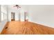 Spacious bedroom with hardwood floors, white walls, and a ceiling fan at 6771 Sunny Brook Ln, Atlanta, GA 30328