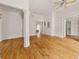 Large bedroom featuring hardwood floors, white walls, and decorative columns at 6771 Sunny Brook Ln, Atlanta, GA 30328