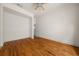 Bright bedroom with hardwood floors, white walls, and ceiling fan at 6771 Sunny Brook Ln, Atlanta, GA 30328