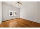 Empty bedroom featuring hardwood floors, white walls, and a ceiling fan at 6771 Sunny Brook Ln, Atlanta, GA 30328