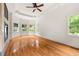Bright bedroom with hardwood floors, bay windows, ceiling fan and fireplace at 6771 Sunny Brook Ln, Atlanta, GA 30328