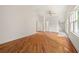 Spacious bedroom featuring hardwood floors, white walls, and natural light from windows at 6771 Sunny Brook Ln, Atlanta, GA 30328