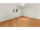 Bright bedroom featuring hardwood floors, white walls, and a ceiling fan at 6771 Sunny Brook Ln, Atlanta, GA 30328
