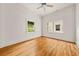 A bright bedroom featuring hardwood floors and plenty of natural light from two windows at 6771 Sunny Brook Ln, Atlanta, GA 30328