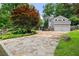 Stone driveway leading up to the house with a two-car garage, surrounded by landscaped greenery at 6771 Sunny Brook Ln, Atlanta, GA 30328