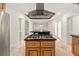 Spacious kitchen with stainless appliances, a stainless vent hood, and large kitchen islands at 6771 Sunny Brook Ln, Atlanta, GA 30328
