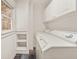 Bright laundry room with a stacked washer and dryer, built-in shelving, and natural light at 6771 Sunny Brook Ln, Atlanta, GA 30328