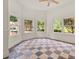 Sunroom with floor-to-ceiling windows, beadboard paneling, and checkered floors at 6771 Sunny Brook Ln, Atlanta, GA 30328
