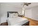 A cozy bedroom features a ceiling fan, hardwood floors, and a closet with white doors for ample storage at 85 Dunwoody Springs Dr, Sandy Springs, GA 30328