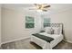 Bedroom with a ceiling fan, neutral carpet, and a bed with decorative pillows and a green throw at 85 Dunwoody Springs Dr, Sandy Springs, GA 30328