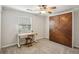 Bedroom featuring a unique Murphy bed, a ceiling fan, neutral carpet, and a desk with a folding chair at 85 Dunwoody Springs Dr, Sandy Springs, GA 30328