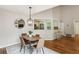 Cozy dining area adjacent to kitchen with modern light fixture and bar seating at 85 Dunwoody Springs Dr, Sandy Springs, GA 30328