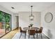 Inviting dining area with modern chandelier and sliding door to outdoor deck at 85 Dunwoody Springs Dr, Sandy Springs, GA 30328