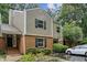 Inviting townhouse with brick facade, black shutters, mature landscaping, and a private entrance at 85 Dunwoody Springs Dr, Sandy Springs, GA 30328