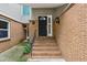 Charming townhouse entrance with brick steps leading to a black front door at 85 Dunwoody Springs Dr, Sandy Springs, GA 30328