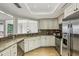 Spacious kitchen with granite countertops and stainless steel appliances, opens to dining area at 85 Dunwoody Springs Dr, Sandy Springs, GA 30328