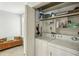 Bright laundry room with washer, dryer, storage shelves, and a bench for convenience at 85 Dunwoody Springs Dr, Sandy Springs, GA 30328