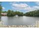 Scenic view of a tranquil pond with a fountain and lush greenery surrounding the water at 85 Dunwoody Springs Dr, Sandy Springs, GA 30328