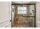 A tiled walk-in shower features mosaic floors, a window, and glass doors at 85 Dunwoody Springs Dr, Sandy Springs, GA 30328