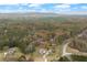 Expansive aerial view showcasing the home amidst lush, mature trees and natural surroundings at 100 Percheron Dr, Canton, GA 30114
