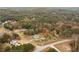 Aerial view of property on a wooded lot with a main house and a detached garage at 100 Percheron Dr, Canton, GA 30114