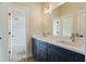 Well lit bathroom featuring double sink vanity, quartz countertop, and tile flooring at 100 Percheron Dr, Canton, GA 30114