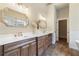 Bright bathroom featuring double vanity, quartz countertop, stylish mirrors, and wood-look tile flooring at 100 Percheron Dr, Canton, GA 30114