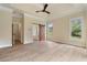 Primary bedroom boasts ceiling fan, tray ceiling, wood floors, and barn door to bath at 100 Percheron Dr, Canton, GA 30114