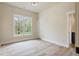 This bedroom has a large window, light hardwood floors, and a neutral paint color at 100 Percheron Dr, Canton, GA 30114