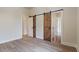 Bedroom featuring sliding barn doors, light hardwood floors, and a neutral paint color at 100 Percheron Dr, Canton, GA 30114