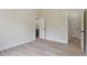 This bedroom offers light hardwood floors, a neutral paint color and two doors at 100 Percheron Dr, Canton, GA 30114