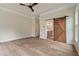 Spacious primary bedroom with wood floors, ceiling fan, and barn door access to bathroom at 100 Percheron Dr, Canton, GA 30114