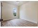 This bedroom features a large window, light hardwood floors, and a neutral paint color at 100 Percheron Dr, Canton, GA 30114