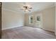 Well-lit bedroom featuring a ceiling fan, neutral walls, and a door leading to the outdoors at 100 Percheron Dr, Canton, GA 30114